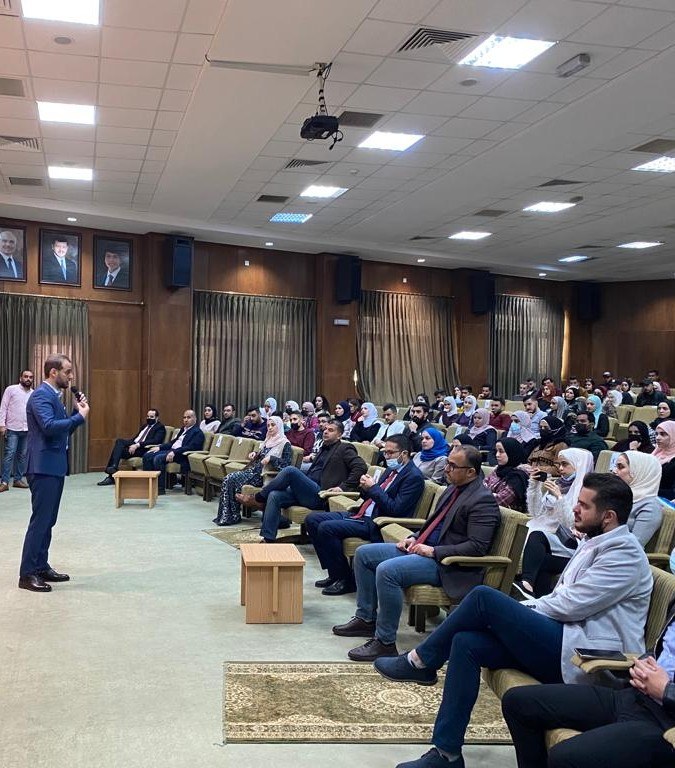 Mohammad speaking with an audience during a development session